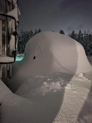 Image of a snow-buried van in December during the middle of the storm