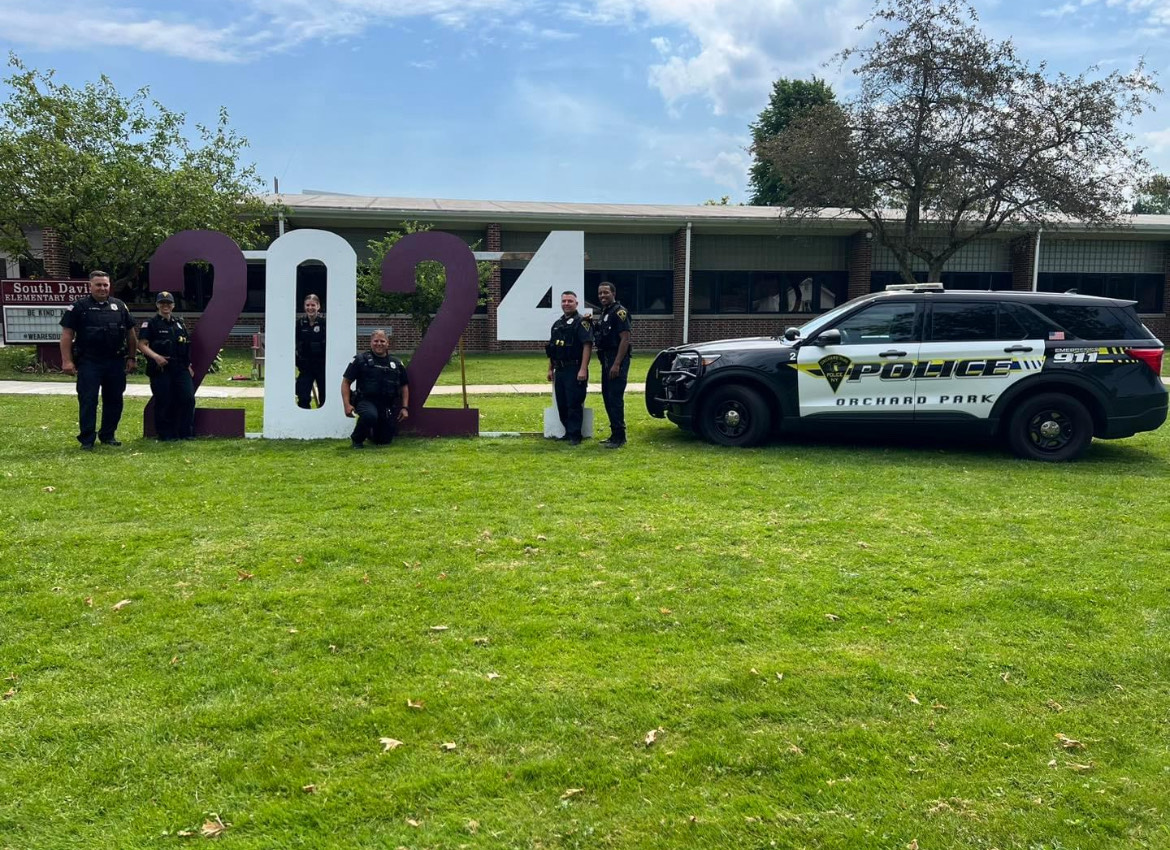 OP Schools SROs pose at the start of school. OPHS's Officer Mackey smiles out from the zero. (Used with permission.)