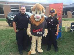 D.A.R.E. Officers Brian Lukowski, Kristen Mazur, and Darren the Lion at Eggert Elementary 