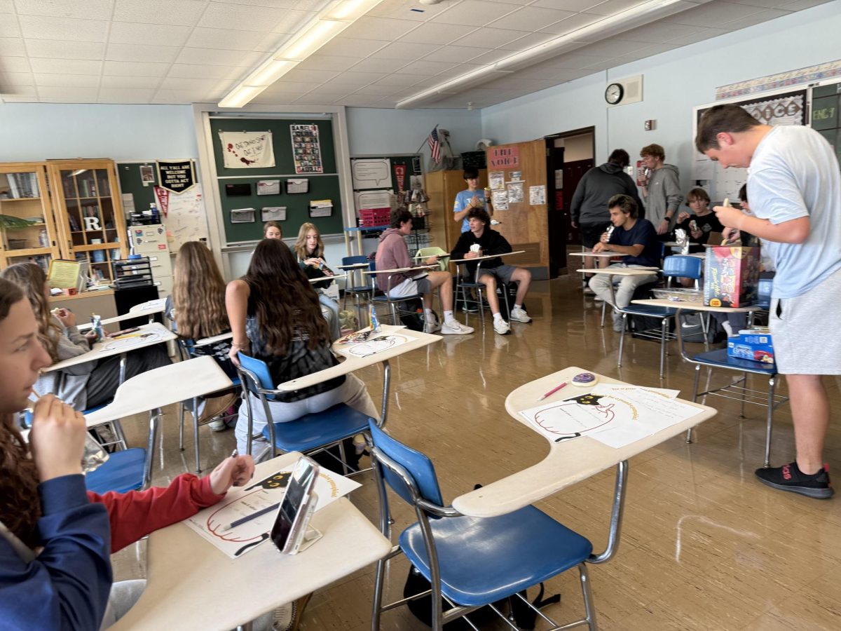 Students practice their grammar skills while enjoying a snack.