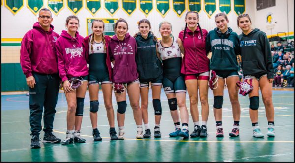 From left to right: Coach Delucia, Olivia Phillips, Lily Sickora, Ella Newell, Cassia Long, Ace Benac, Sophia Saffrin, Marissa Tara, and Adrianna Tara 