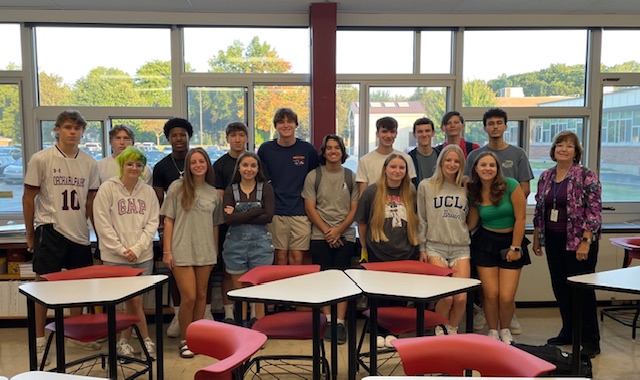 Mrs. Henault (right) pictured with her senior homeroom. Interviewer Scout Moskal pictured center-left. 